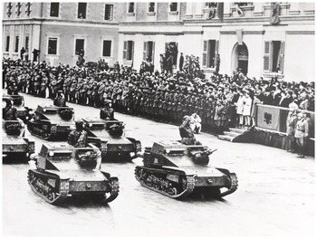 Black-and-white photo of soldiers and tanks at a parade